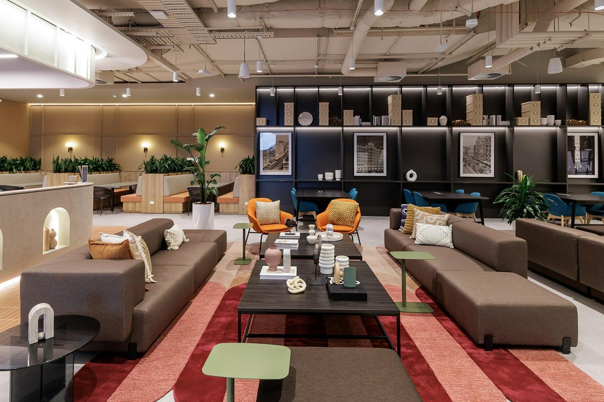 Shared lounge with sofas, armchairs and styled bookshelves in a serviced office at 287 Lonsdale Street, Melbourne